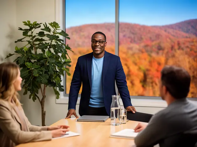 A smiling consultant leads a meeting with two clients in a bright conference room.