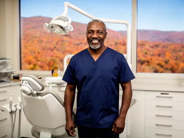 A smiling dentist in navy scrubs beside a dental chair by a window onto autumn ridges.